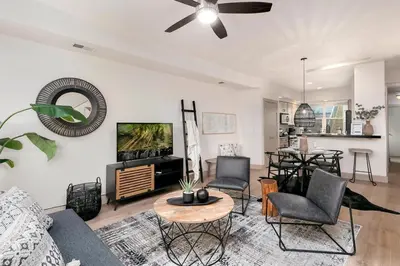 a living room with a couch and chairs and a tv at Hip Old Town North Gem! Near Breweries and River! in Fort Collins