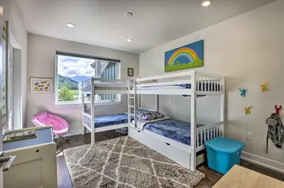 a bedroom with two bunk beds and a window at Walk to Lifts Condo with Mtn Views in Keystone! in Keystone