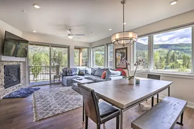 a living room with a table and a couch at Walk to Lifts Condo with Mtn Views in Keystone! in Keystone