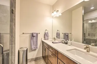 a bathroom with a sink and a large mirror at Walk to Lifts Condo with Mtn Views in Keystone! in Keystone
