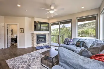 a living room with a couch and a fireplace at Walk to Lifts Condo with Mtn Views in Keystone! in Keystone