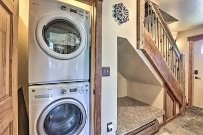 a washer and dryer in a house with a staircase at 3-Story Home with Balcony about 6 Mi to Winter Park! in Fraser