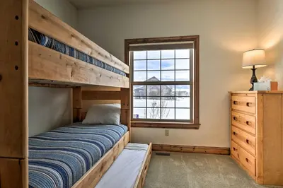 a bedroom with two bunk beds and a window at Luxe Rocky Mtn Retreat with Hot Tub - By Winter Park in Tabernash