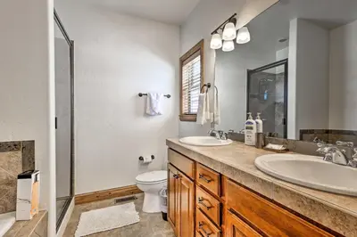 a bathroom with two sinks and a toilet and a shower at Luxe Rocky Mtn Retreat with Hot Tub - By Winter Park in Tabernash