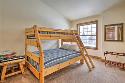 a bedroom with a bunk bed with a ladder at Luxe Rocky Mtn Retreat with Hot Tub - By Winter Park in Tabernash