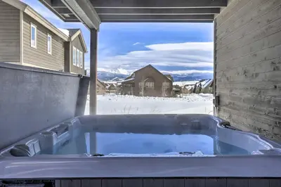 a jacuzzi tub on the back of a house at Luxe Rocky Mtn Retreat with Hot Tub - By Winter Park in Tabernash
