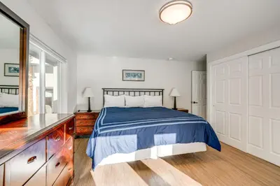 a bedroom with a bed and a dresser and a mirror at Luxury Keystone Cabin with Hot Tub, 1 Mi to Lifts! in Keystone