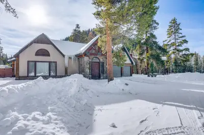 a house with a pile of snow in front of it at Luxury Keystone Cabin with Hot Tub, 1 Mi to Lifts! in Keystone