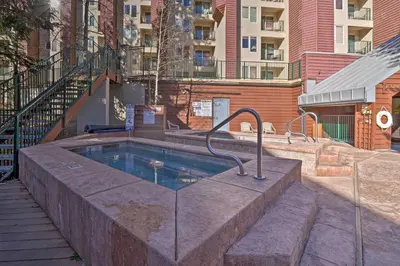 a swimming pool in the middle of a building at Cozy Ski-InandOut Winter Park Studio with Hot Tubs! in Winter Park