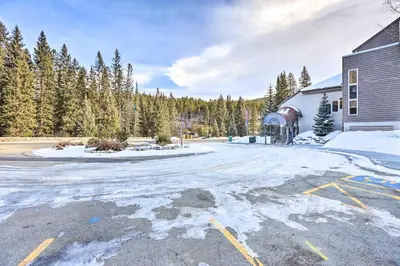 an empty parking lot in front of a building at Cozy Ski-InandOut Winter Park Studio with Hot Tubs! in Winter Park