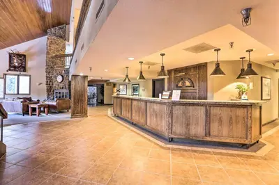 a lobby with a bar and a living room at Cozy Ski-InandOut Winter Park Studio with Hot Tubs! in Winter Park