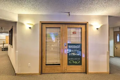 a door in a room with a sign on it at Cozy Ski-InandOut Winter Park Studio with Hot Tubs! in Winter Park