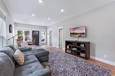 a living room with a couch and a tv at Cozy Chic Home In Downtown Loveland! in Loveland