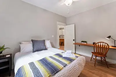 a bedroom with a bed and a desk and a chair at Cozy Chic Home In Downtown Loveland! in Loveland