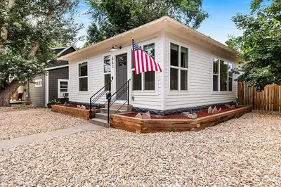 a house with an american flag in front of it at Cozy Chic Home In Downtown Loveland! in Loveland