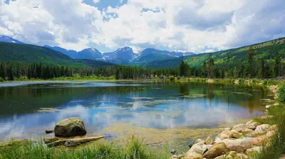 a large lake with mountains in the background at Cozy Chic Home In Downtown Loveland! in Loveland