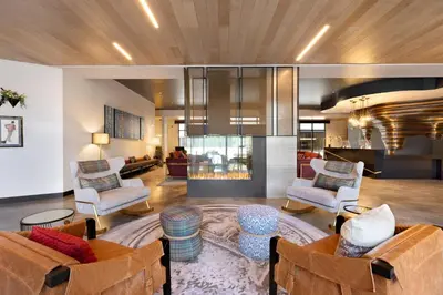 a living room with couches and chairs and a lobby at Hotel Indigo - Silverthorne by IHG in Silverthorne