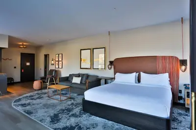 a bedroom with a bed and a living room at Hotel Indigo - Silverthorne by IHG in Silverthorne