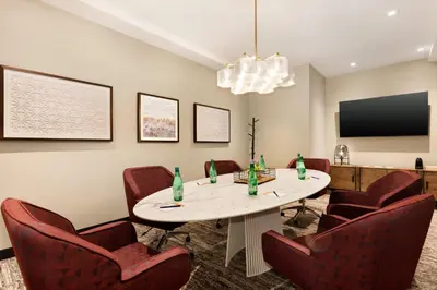 a conference room with a table and red chairs at Hotel Indigo - Silverthorne by IHG in Silverthorne