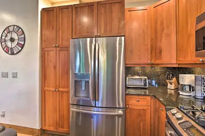 a stainless steel refrigerator in a kitchen with wooden cabinets at Private Hot Tub Family Townhome in Breckenridge in Breckenridge