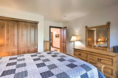 a bedroom with a bed and a dresser and a mirror at Private Hot Tub Family Townhome in Breckenridge in Breckenridge