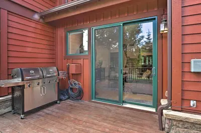 a screened in porch with a grill on a patio at Private Hot Tub Family Townhome in Breckenridge in Breckenridge