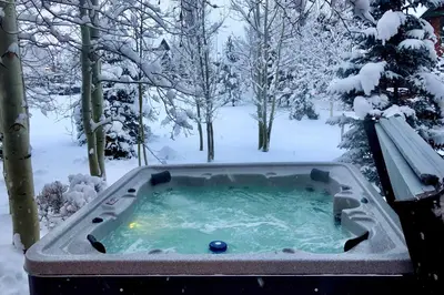 a jacuzzi tub in a snow covered yard at Private Hot Tub Family Townhome in Breckenridge in Breckenridge