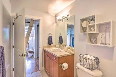 a bathroom with a sink and a toilet and a mirror at 5 Mi to Ski Resort Breck Penthouse Studio in Breckenridge