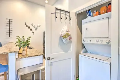 a kitchen with an open door and a refrigerator at 5 Mi to Ski Resort Breck Penthouse Studio in Breckenridge
