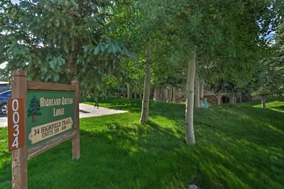 a sign in the grass next to a park with trees at 5 Mi to Ski Resort Breck Penthouse Studio in Breckenridge