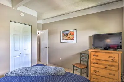 a bedroom with a bed and a tv on a dresser at Frisco Condo 2 Blocks to Main St Year-Round Fun! in Frisco