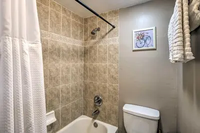 a bathroom with a shower and a toilet and a sink at Frisco Condo 2 Blocks to Main St Year-Round Fun! in Frisco