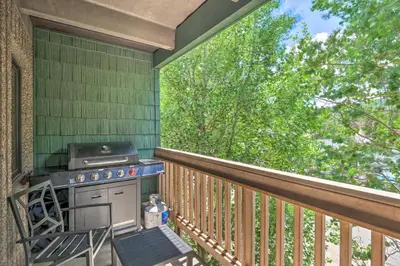 a porch with a stove and a chair on a deck at Frisco Condo 2 Blocks to Main St Year-Round Fun! in Frisco