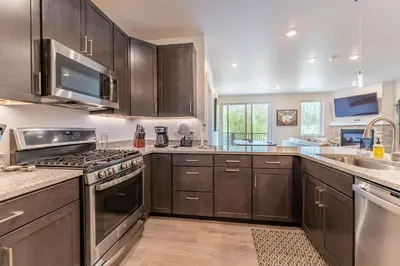 a kitchen with wooden cabinets and stainless steel appliances at Clearwater Lofts 107 Building 3 in Keystone