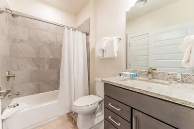 a bathroom with a toilet and a tub and a sink at Clearwater Lofts 107 Building 3 in Keystone
