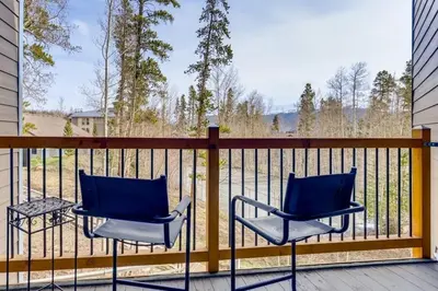 two chairs on a balcony with a view of the water at F201 Treehouse condo in Silverthorne