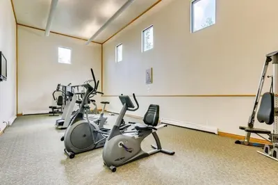 a row of exercise bikes in a room with windows at F201 Treehouse condo in Silverthorne