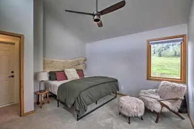 a bedroom with a bed and a ceiling fan at Modern Evergreen Duplex Off I-70 with Mountain Views in Idaho Springs