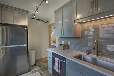 a kitchen with gray cabinets and a sink at Modern Evergreen Duplex Off I-70 with Mountain Views in Idaho Springs