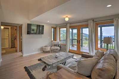 a living room with a couch and a table at Modern Evergreen Duplex Off I-70 with Mountain Views in Idaho Springs