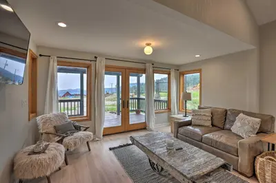 a living room with a couch and a table at Modern Evergreen Duplex Off I-70 with Mountain Views in Idaho Springs