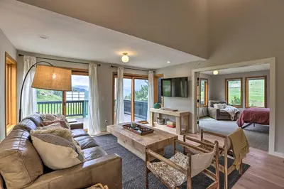 a living room with a couch and a table at Evergreen Mountain Duplex with Trail Access! in Idaho Springs