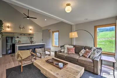 a living room with a couch and a table at Evergreen Mountain Duplex with Trail Access! in Idaho Springs