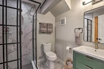 a bathroom with a shower and a toilet and a sink at Evergreen Mountain Duplex with Trail Access! in Idaho Springs