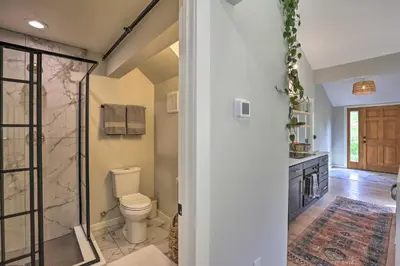 a bathroom with a toilet and a walk in shower at Evergreen Mountain Duplex with Trail Access! in Idaho Springs
