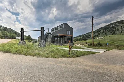 a house sitting on the side of a road at Evergreen Mountain Duplex with Trail Access! in Idaho Springs