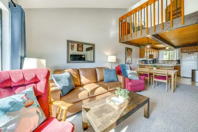 a living room with a couch and a table at Warm Fraser Townhome with Community Amenities! in Fraser