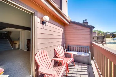 two chairs and a table on a balcony at Warm Fraser Townhome with Community Amenities! in Fraser