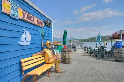 a statue of a man sitting on a bench next to a building at Mountain luxury on Lake Dillon, close to all the best ski resorts in Colorado! in Dillon