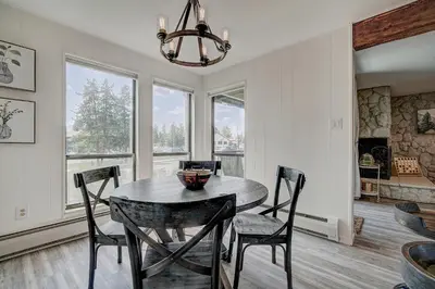 a dining room with a table and chairs and a chandelier at Mountain luxury on Lake Dillon, close to all the best ski resorts in Colorado! in Dillon